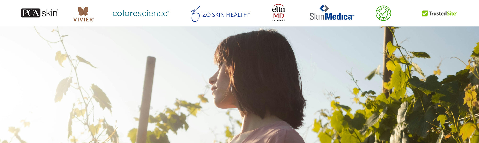 Woman in soft summer light surrounded by vineyard leaves promoting natural skincare with Skin Boutique Online